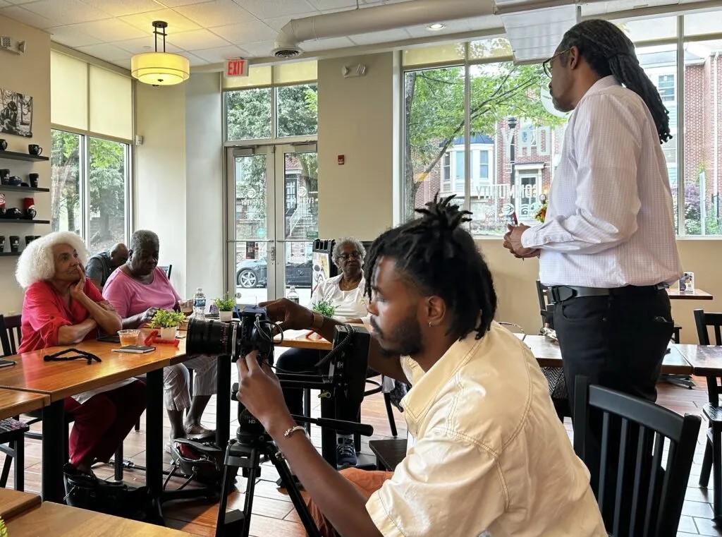 August Wilson House board President Ervin Dyer prepares participants gathered last year for an Everyday Cafe story circle.