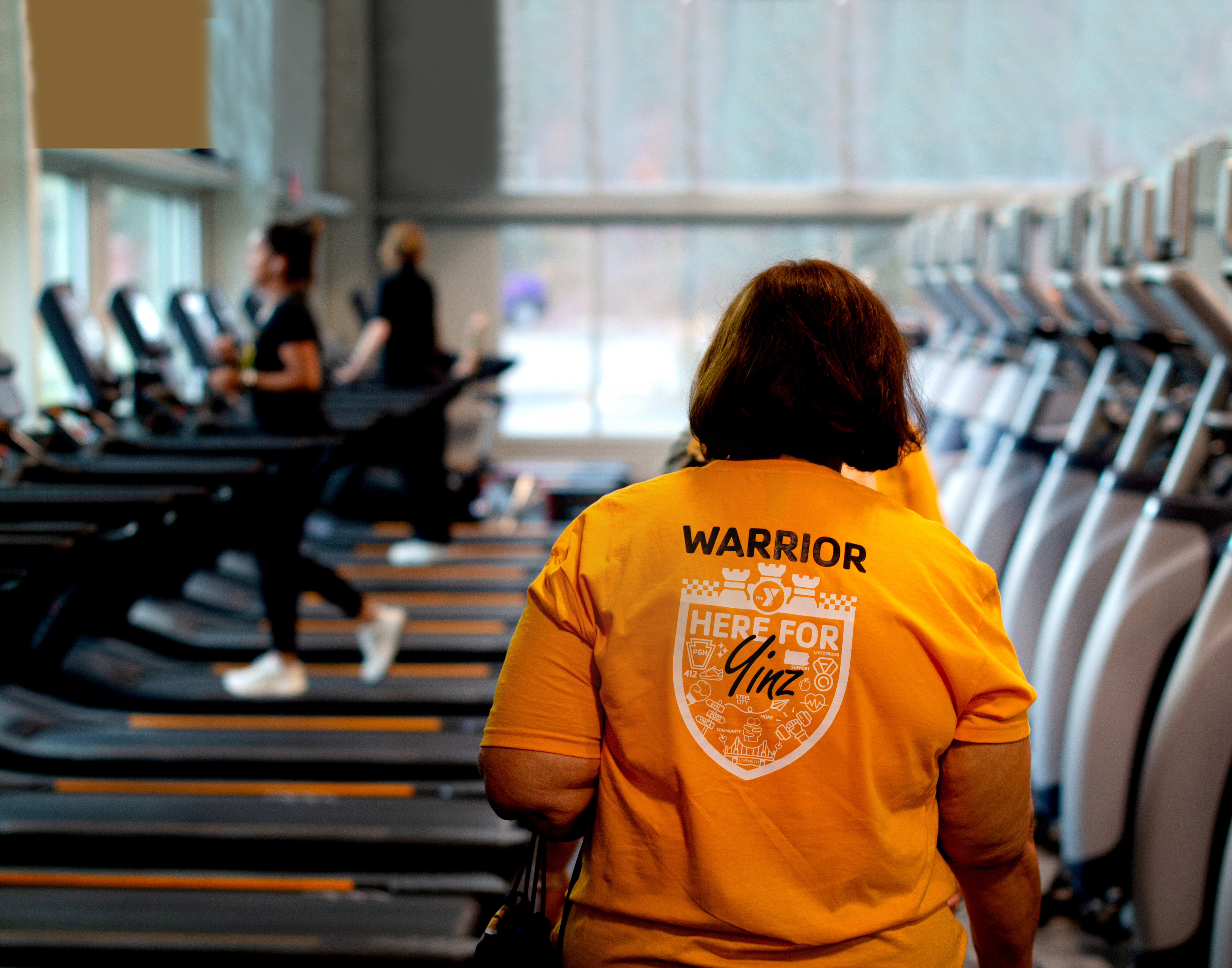 The back of a member with a LIVESTRONG shirt on