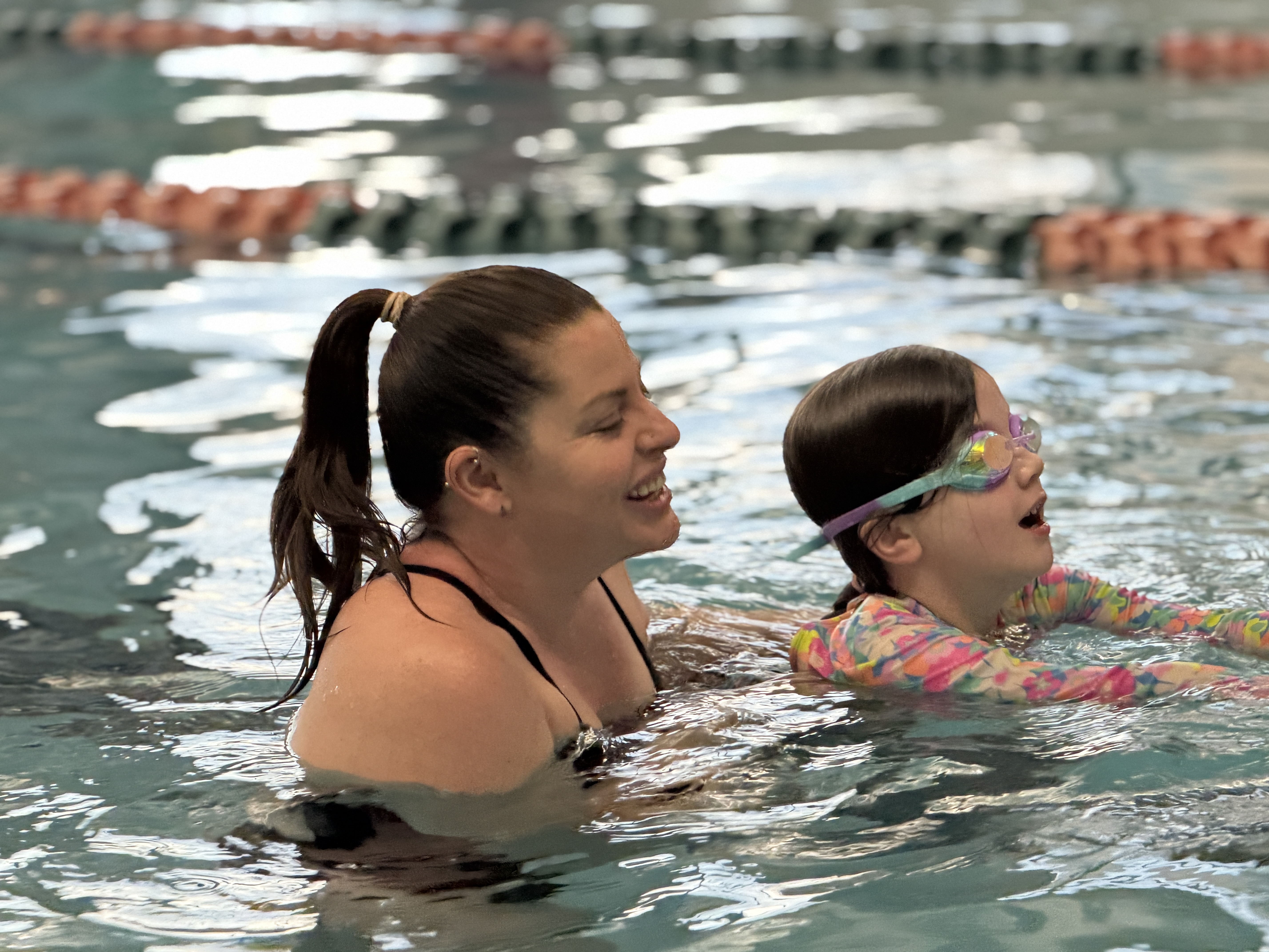 Swim instructor teaching child