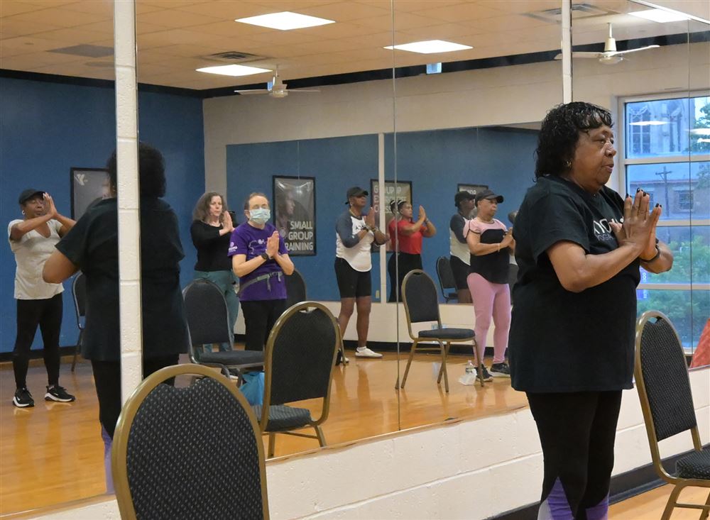 Instructor teaching a chair yoga class