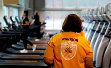 The back of a member with a LIVESTRONG shirt on