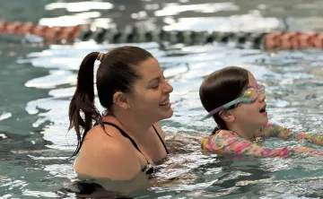 Swim instructor teaching child