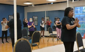 Instructor teaching a chair yoga class